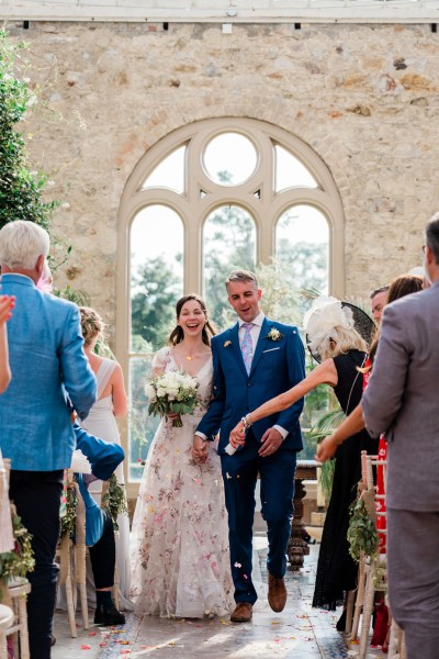 Wedding photography Jane & Alex happy couple smiling flowers church guests clapping confetti