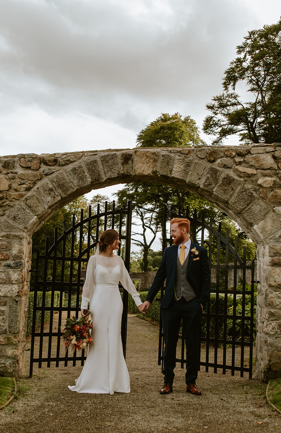 bride and groom laughing at castle outdoors