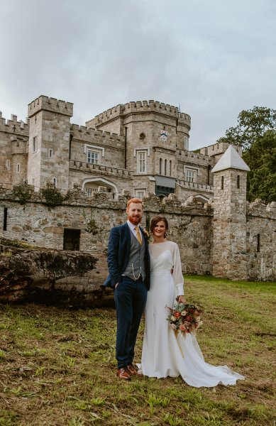 bride and groom laughing at castle outdoors