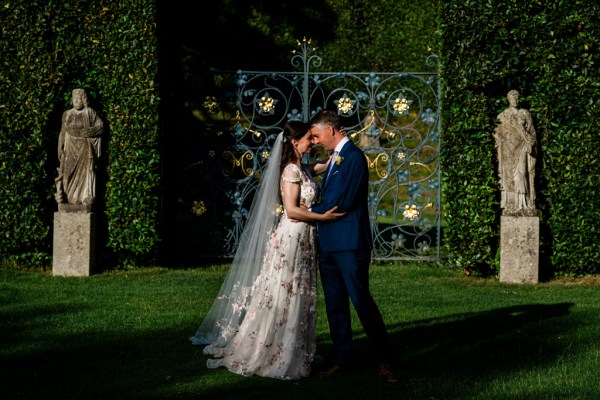 Wedding photography Jane & Alex exterior couple hotel photography summer dress detail gate embrace hug