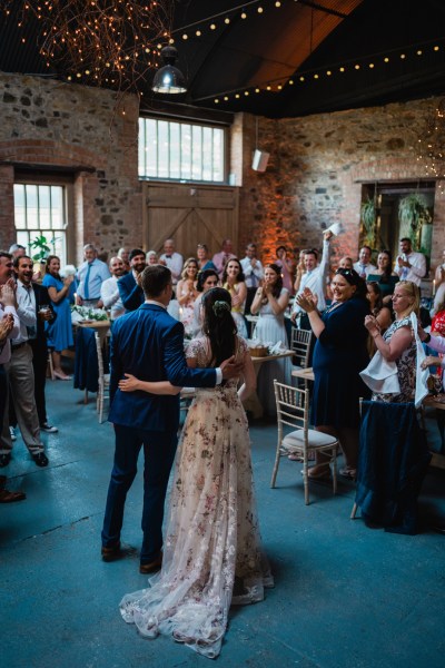 Wedding photography Jane & Alex interior dining guests family eating drinking clapping bride groom