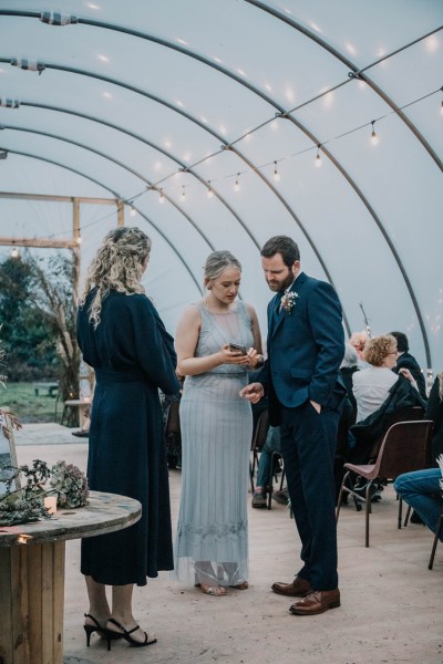 Aisling & Forbes Real Wedding officiate officiant groom phone flowers