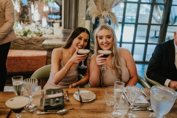 Cocktail drinking guests bridesmaids at dining table