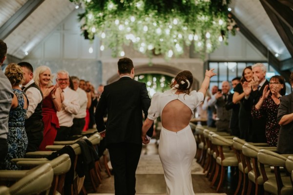 Bride and groom enter dining room guests clapping