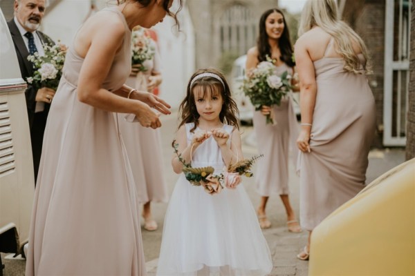 Flower girl bouquet of flowers bridesmaids maid of honour friend exterior shot