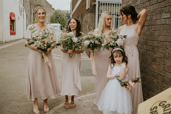 Flower girl bouquet of flowers bridesmaids maid of honour friend exterior shot