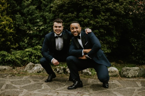 Groom and groomsman best man exterior smiling park shot