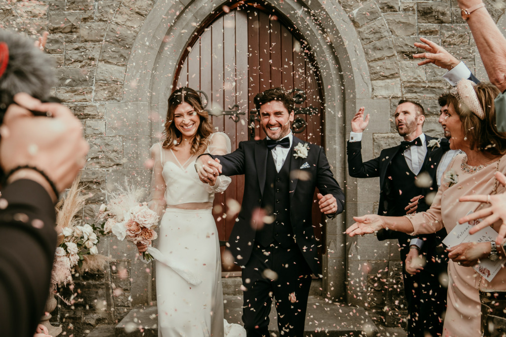 Jemma & Oissine Real Wedding confetti on couple guests happy smiles clapping