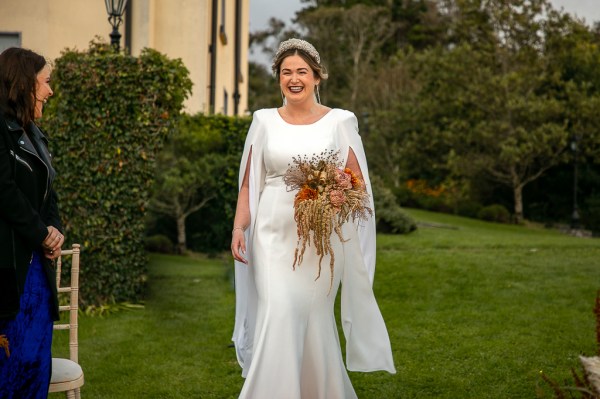 Real Wedding: Tracey & Ultan smiling laughing bride head band sequinned diamonds exterior flowers