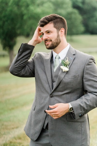 Close up of groom suit detail flower exterior jacket farm