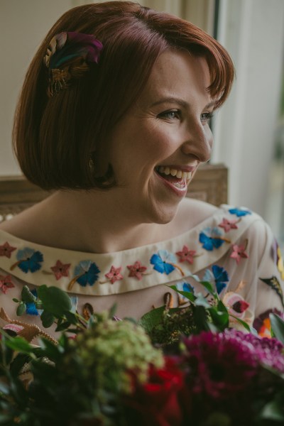 Up close close-up of bride laughing smiling bouquet of flowers