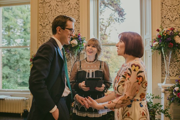 Interior bride and groom floral flowers dress officiant officiate ceremony