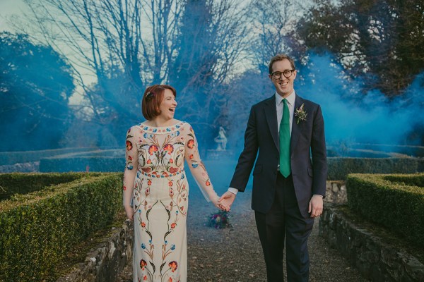 Bride and groom exterior bouquet of flowers exterior garden holding hands blue hue photography smoke