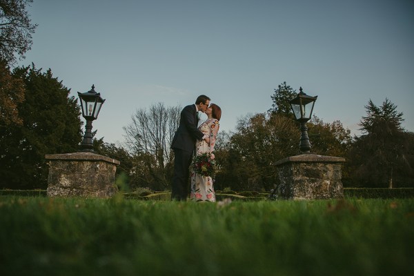 Bride and groom champagne prosecco wine exterior bouquet of flowers exterior garden kissing