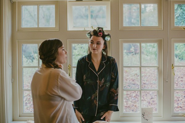 Interior bridesmaids getting ready rollers in hair curly before ceremony