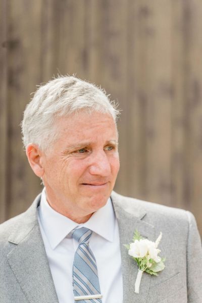 Father of the bride close up suit jacket flower