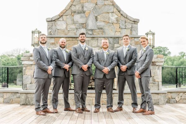 Groom groomsmen smiling exterior laughing