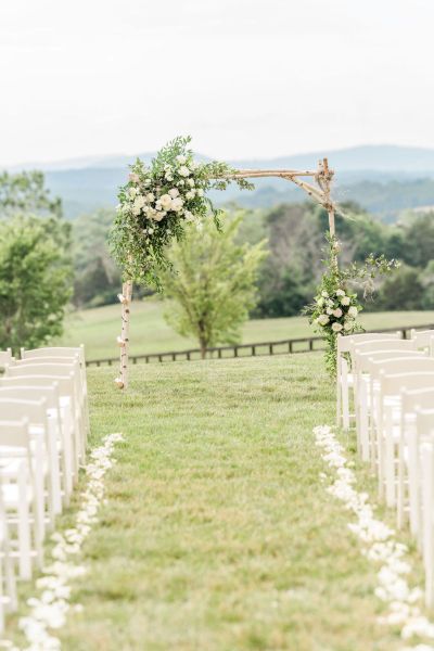 Empty aisle ceremony shot flowers floral petals roses exterior