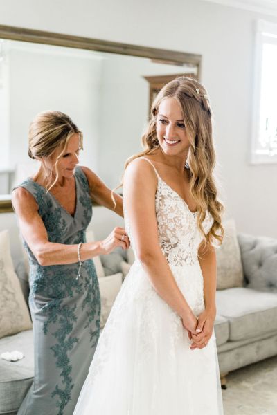 Bride getting ready bridesmaid hair lace dress detail interior