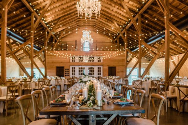 Interior lights wooden barn seating area dining candle food guests