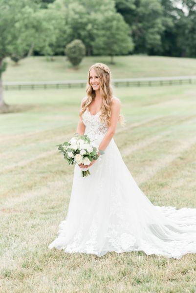 Bride lace dress white bouquet of flowers exterior farm tree hair detail