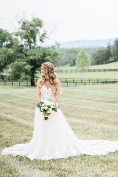 Bride lace dress white bouquet of flowers exterior farm tree hair detail