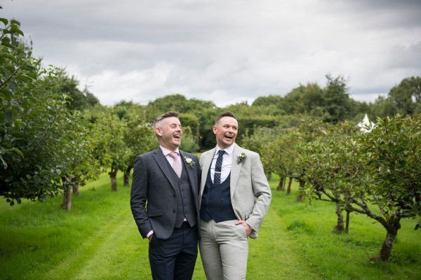 Eoin & Darran Real Wedding groom and groom couple laughing exterior green trees