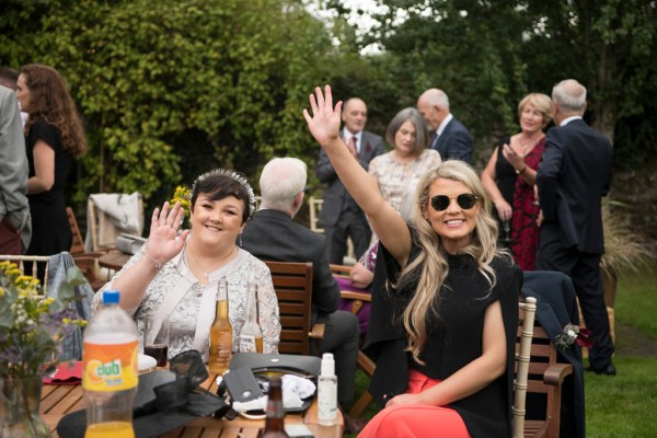 Eoin & Darran Real Wedding guests waving glasses exterior drinks happy