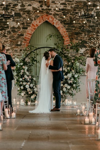 bride and groom ceremony aisle kissing