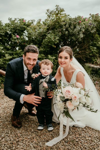 bride and groom with baby son