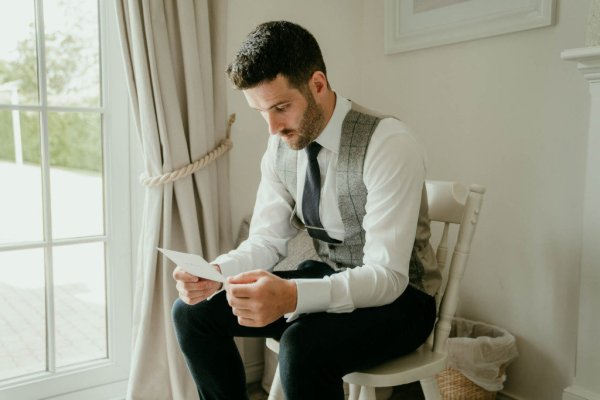 groom reading letter from bride