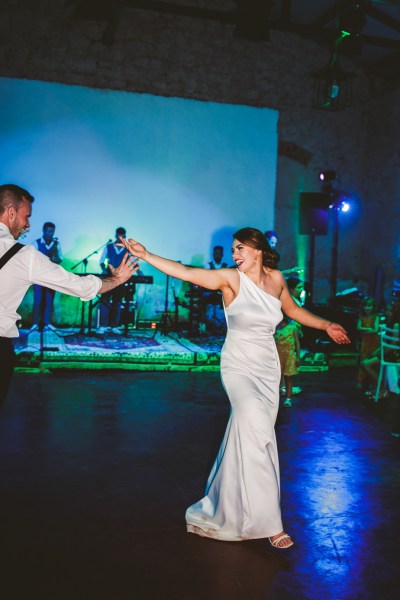 Bride and groom dancing first dance dancefloor guests live music