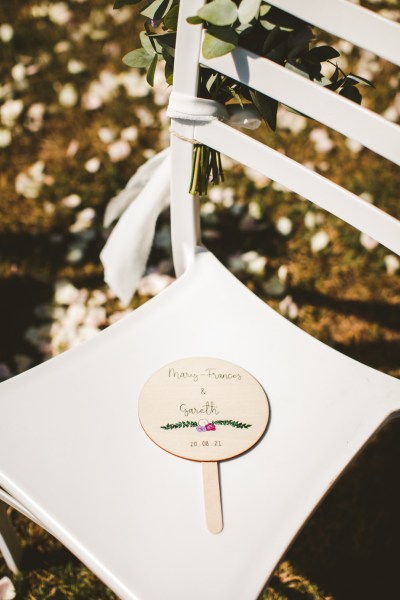 Chair detail lollipop names card flowers ceremony exterior