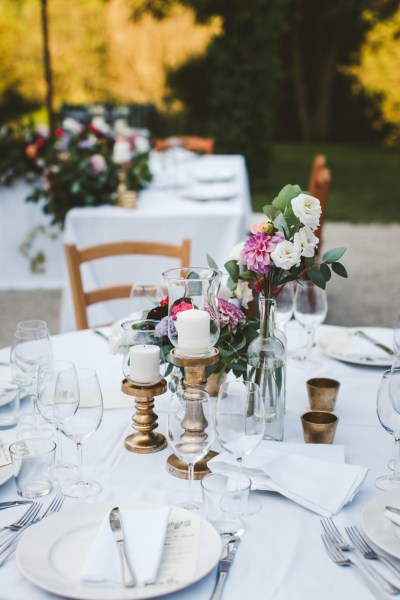 Close-up rose flower detail on dining table champagne wine glasses