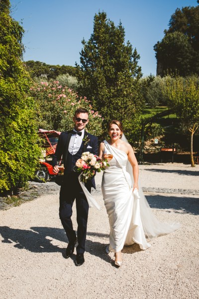 Bride groom couple walking sunshine sunny caddy car exterior flowers bouquet