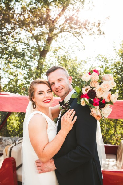 Bride groom couple embrace hug caddy car exterior flowers bouquet