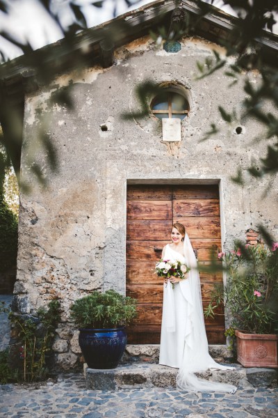 Bride on her own exterior barn door bouquet flowers