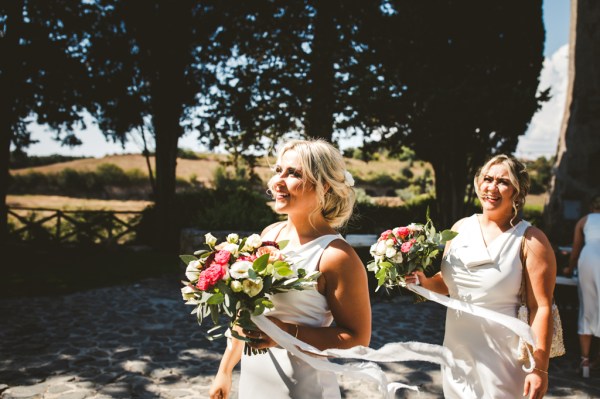 Bridesmaids walking exterior bouquet flowers hair bride