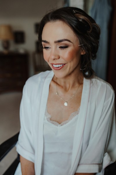 Bride getting ready MUA smiling happy hair makeup