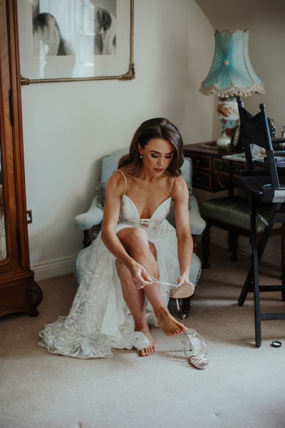 Bride getting ready shoe detail dress interior before ceremony