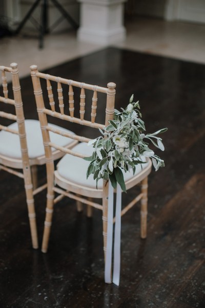 Candle flowers table ceremony room ceremonial chair ribbon