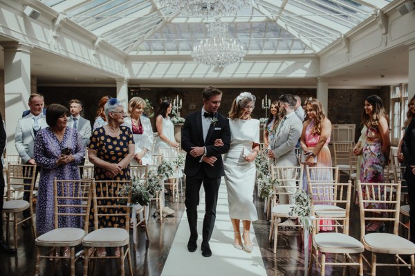 Groom mother guests aisle ceremony interior