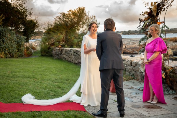 Real Wedding Tracey & Ultan happy laughing bride groom exterior sea