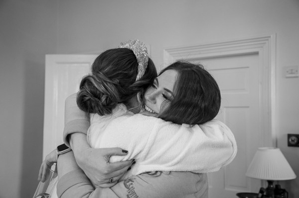 Real Wedding Tracey & Ultan bridesmaid bride hugging embracing hair detail