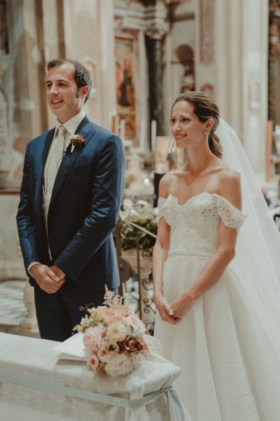 bride and groom at altar