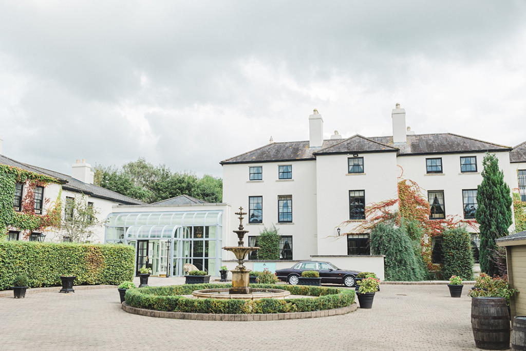 Exterior shot of hotel castle fountain ivory windows wedding