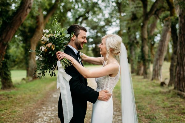 bride and groom outside trees