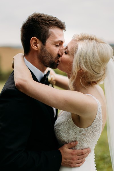 kissing bride and groom