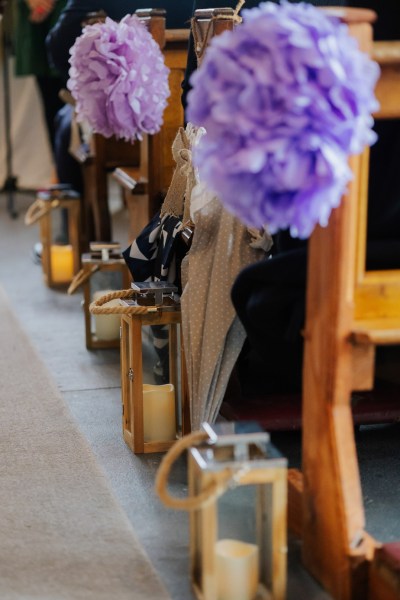 Church decor purple and lanterns with candles Olga Hogan Photography: Hannah & Eoghan