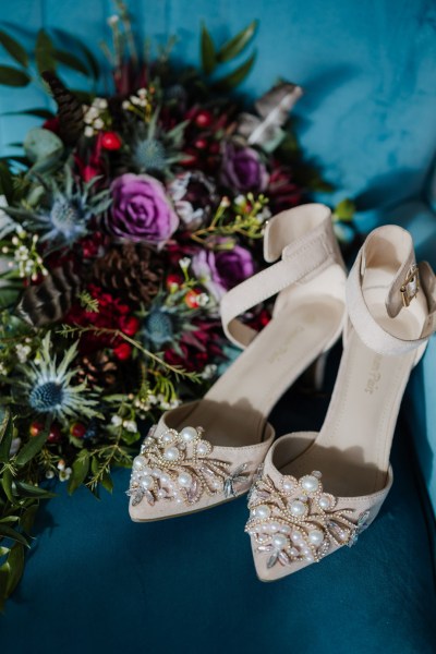 Bridal shoes with pearls and bridal bouquets with thistles of blue, pink and red Olga Hogan Photography: Hannah & Eoghan